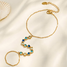 White cubic zirconia hand chain bracelet with polished gold stainless steel finish