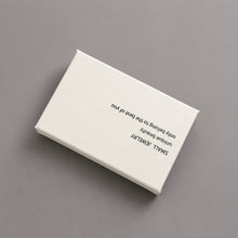 Close-up of a white and blush pink jewelry box with printed lid for boutique jewelry gift packaging