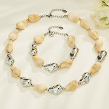 White resin necklace and bracelet set with irregular organic beads and contrasting metal accents