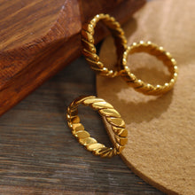 Wholesale gold rings display featuring 316L stainless steel jewelry designs