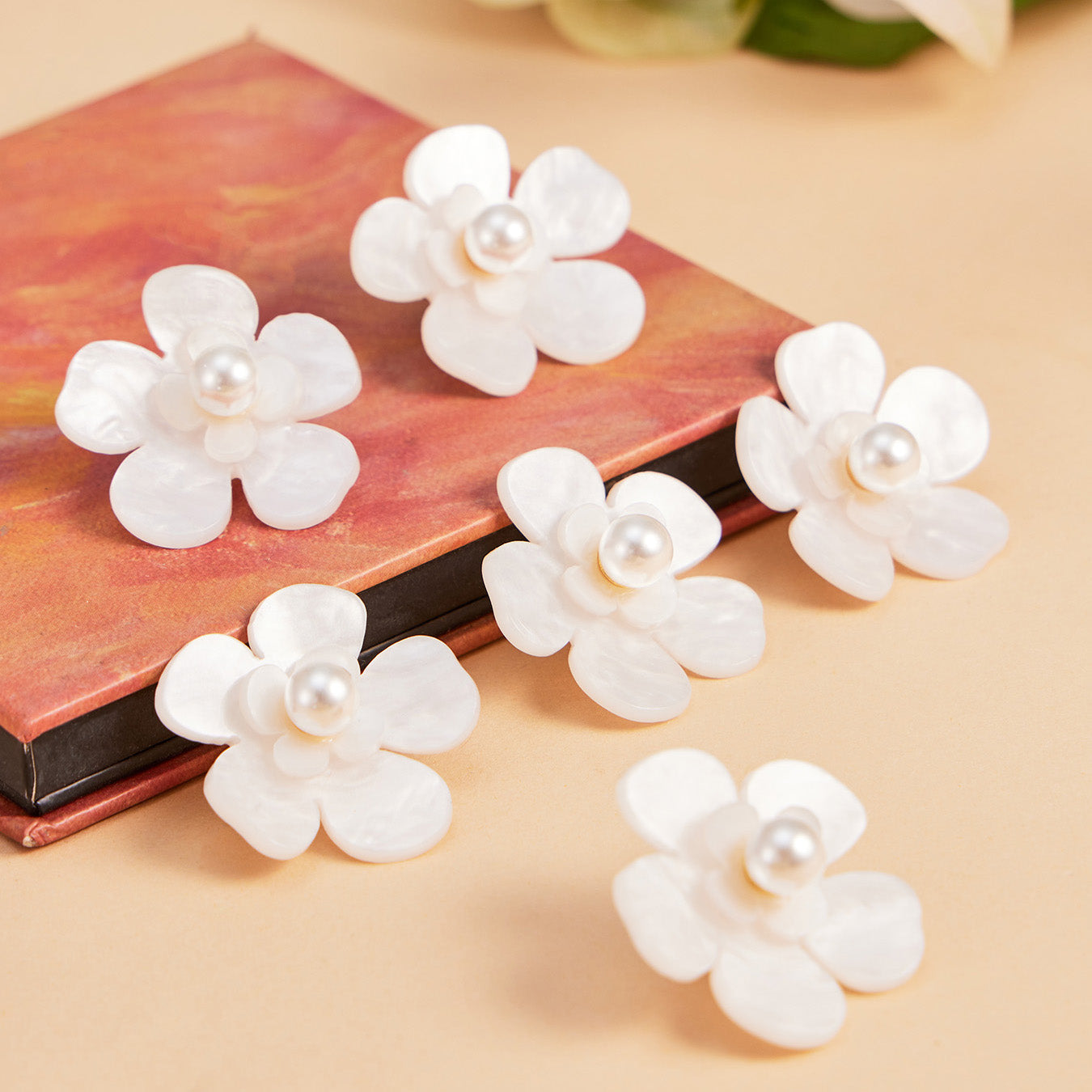 Boutique display of white pearl flower earrings with soft styling