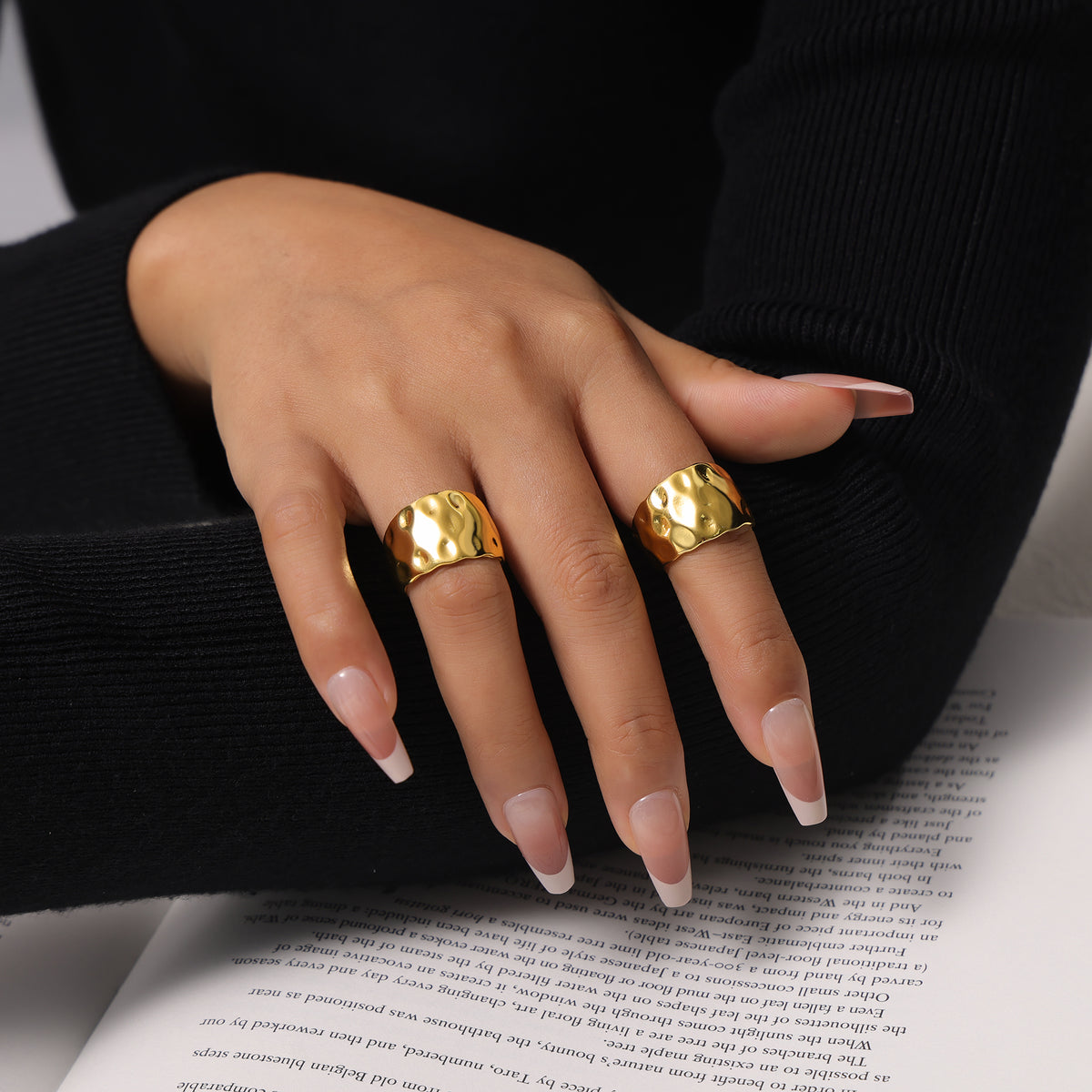 Wide band hammered gold ring styled as a bold statement ring