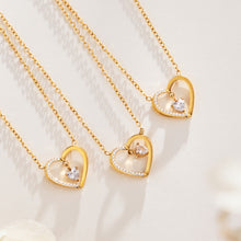 Gold-tone zircon heart pendant necklaces displayed together in a jewelry flat lay