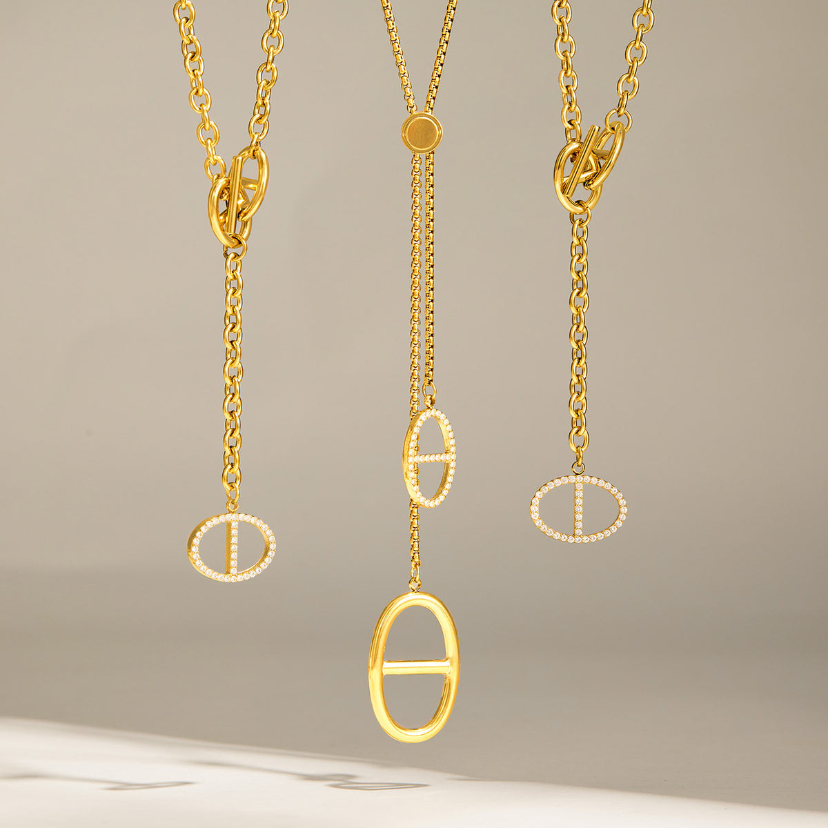 Gold zircon necklace designs showing long lariat and shorter toggle drop styles