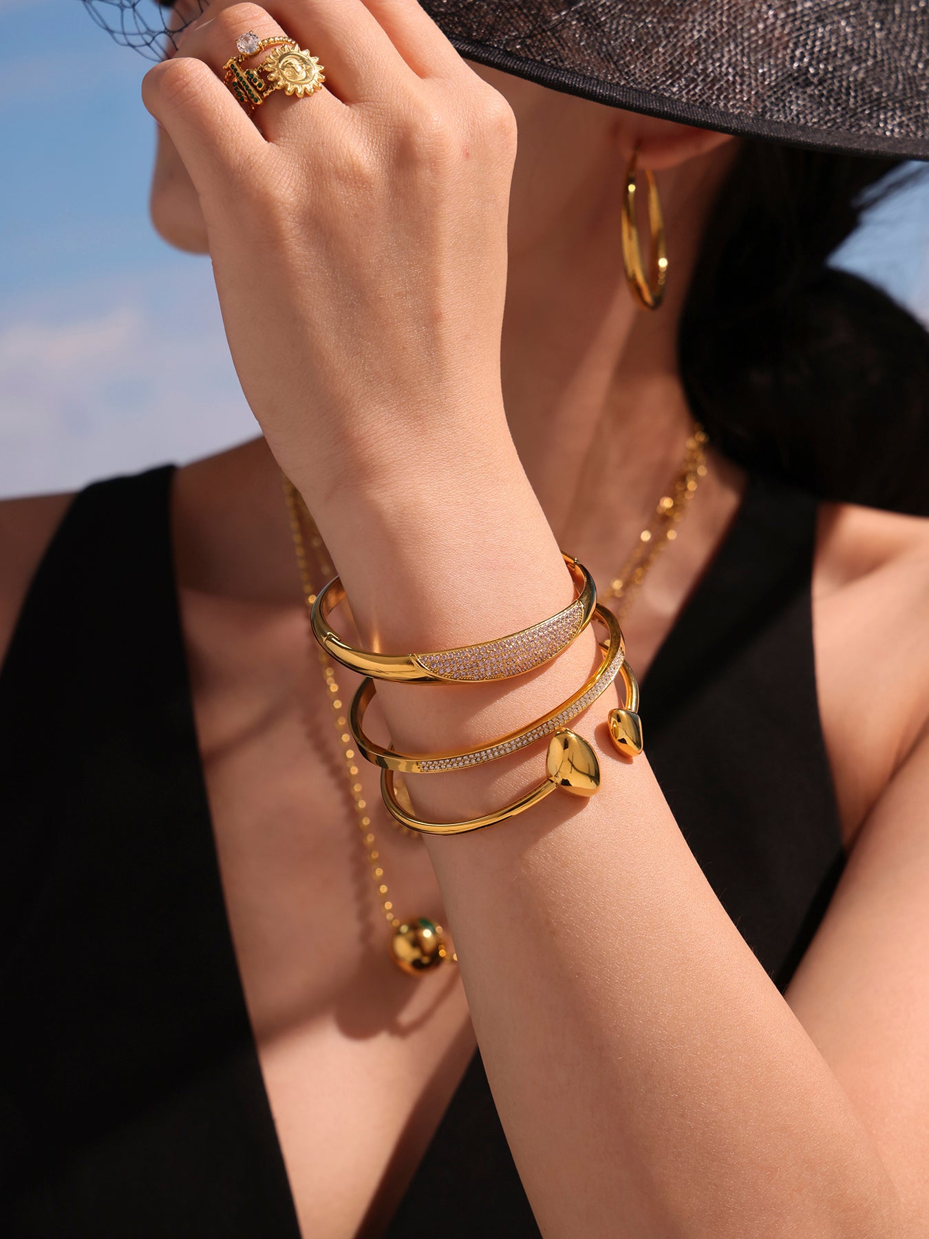 zircon paved slender bangle model front view - gold crystal bangle styling with black outfit