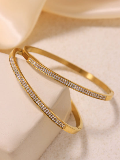 zircon paved slender bangle scene styling - double gold zircon bangles displayed on fabric