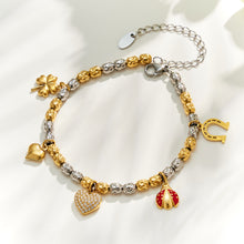 Steel finish multi charm bracelet with heart, horseshoe and colorful pendant details